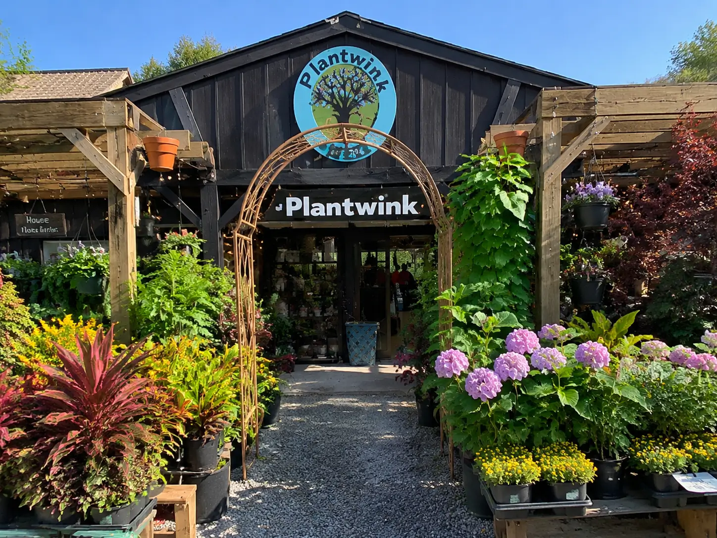 The Plantwink garden shop entrance surrounded by colorful plants and flowers
